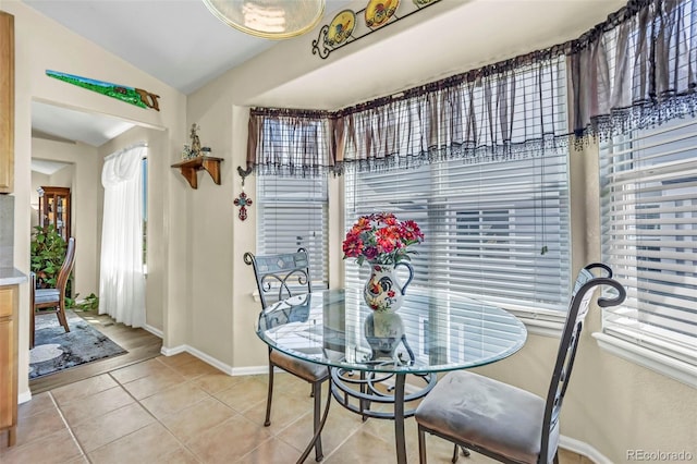 16048 Butterwort Cir, Parker, CO 80134 - dining area featuring vaulted ceiling, baseboards, and light tile patterned floors