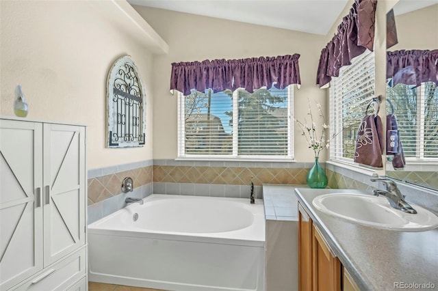 16048 Butterwort Cir, Parker, CO 80134 - bathroom featuring lofted ceiling, vanity, and a garden tub