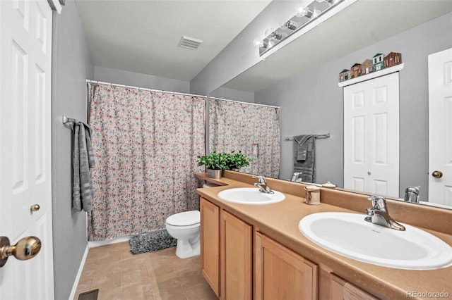 16048 Butterwort Cir, Parker, CO 80134 - bathroom featuring double vanity, visible vents, toilet, and a sink