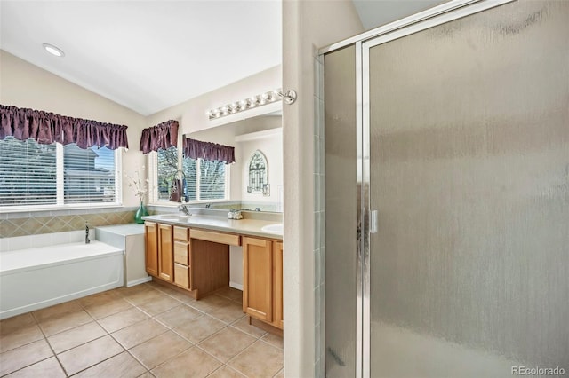 16048 Butterwort Cir, Parker, CO 80134 - bathroom with double vanity, vaulted ceiling, tile patterned flooring, a shower stall, and a garden tub