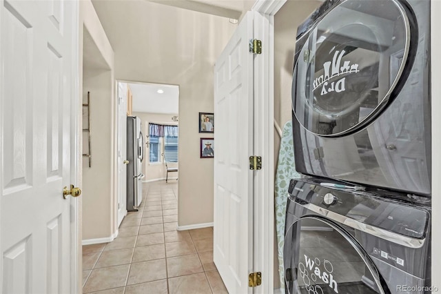 16048 Butterwort Cir, Parker, CO 80134 - laundry room with baseboards, stacked washing maching and dryer, laundry area, and light tile patterned floors