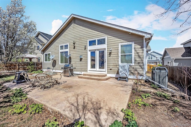 16048 Butterwort Cir, Parker, CO 80134 - back of house featuring a fenced backyard, entry steps, central air condition unit, and a patio
