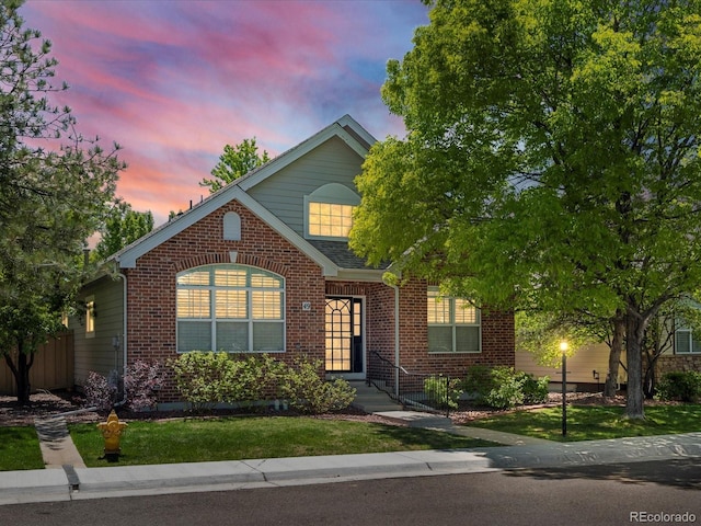 6900 W Grant Ranch Blvd Unit 49, Littleton, CO 80123 - traditional home featuring brick siding and a lawn