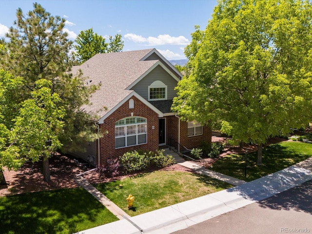 6900 W Grant Ranch Blvd Unit 49, Littleton, CO 80123 - view of front of property with brick siding, a front lawn, and a shingled roof