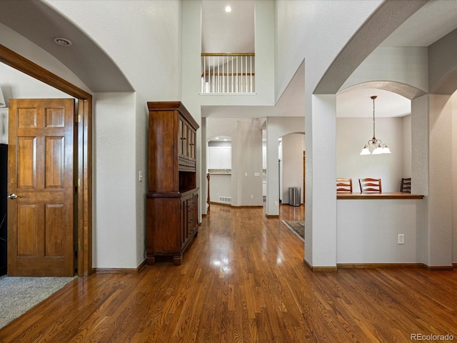 6900 W Grant Ranch Blvd Unit 49, Littleton, CO 80123 - foyer featuring arched walkways, dark wood-type flooring, and baseboards