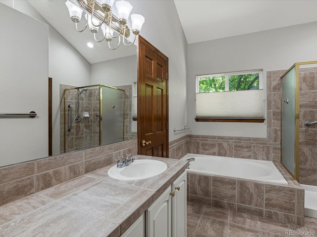 6900 W Grant Ranch Blvd Unit 49, Littleton, CO 80123 - bathroom with a garden tub, a shower stall, vaulted ceiling, vanity, and a chandelier