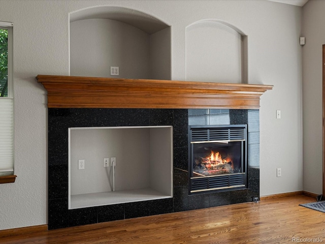 6900 W Grant Ranch Blvd Unit 49, Littleton, CO 80123 - detailed view of wood finished floors, a tile fireplace, and baseboards