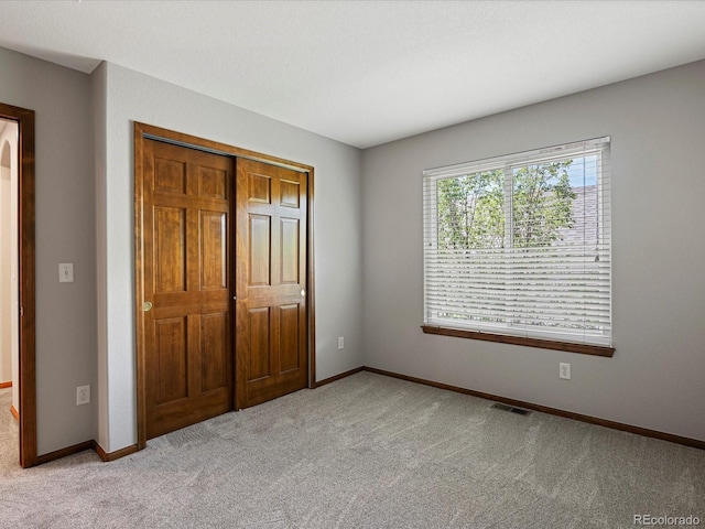 6900 W Grant Ranch Blvd Unit 49, Littleton, CO 80123 - unfurnished bedroom with light colored carpet, a closet, and baseboards