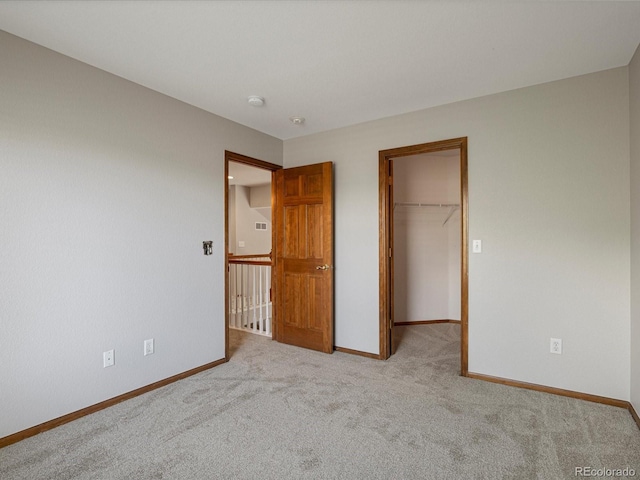 6900 W Grant Ranch Blvd Unit 49, Littleton, CO 80123 - unfurnished bedroom featuring carpet floors, a walk in closet, baseboards, and a closet