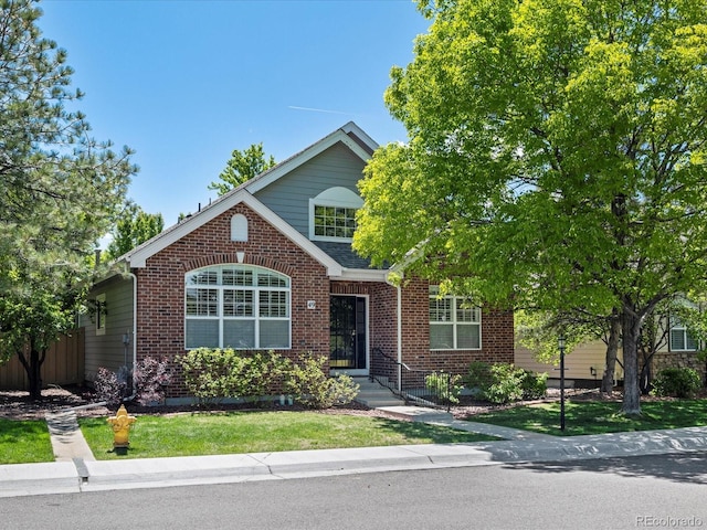 6900 W Grant Ranch Blvd Unit 49, Littleton, CO 80123 - view of front facade featuring brick siding and a front lawn