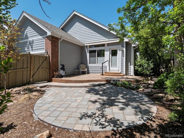 6900 W Grant Ranch Blvd Unit 49, Littleton, CO 80123 - back of property featuring a patio area, entry steps, and brick siding