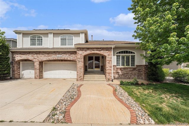 10155 Charissglen Ln, Littleton, CO 80126 - view of front of house featuring driveway, a garage, and brick siding