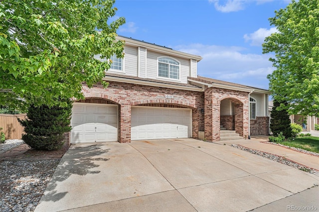 10155 Charissglen Ln, Littleton, CO 80126 - view of front facade with brick siding, driveway, and an attached garage