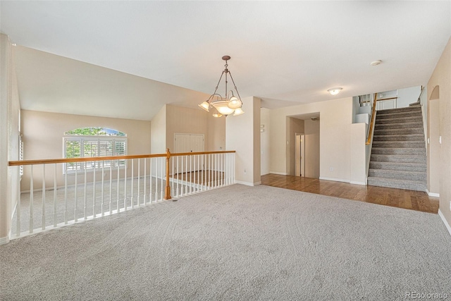 10155 Charissglen Ln, Littleton, CO 80126 - carpeted spare room with baseboards, a chandelier, and stairs