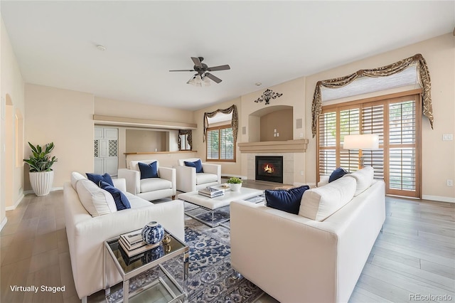 10155 Charissglen Ln, Littleton, CO 80126 - living area with a ceiling fan, healthy amount of natural light, baseboards, and wood finished floors
