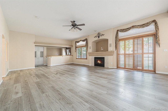 10155 Charissglen Ln, Littleton, CO 80126 - unfurnished living room featuring ceiling fan, wood finished floors, a tile fireplace, and baseboards