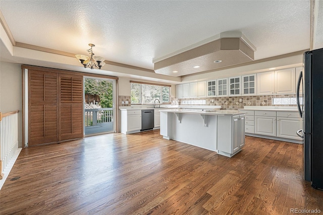 10155 Charissglen Ln, Littleton, CO 80126 - kitchen with a sink, freestanding refrigerator, a chandelier, a tray ceiling, and tasteful backsplash