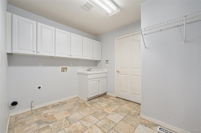 10155 Charissglen Ln, Littleton, CO 80126 - washroom featuring hookup for a washing machine, baseboards, cabinet space, hookup for an electric dryer, and light stone finish floors