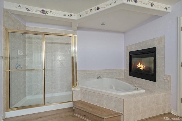 10155 Charissglen Ln, Littleton, CO 80126 - full bathroom with wood finished floors, a garden tub, a shower stall, and a fireplace