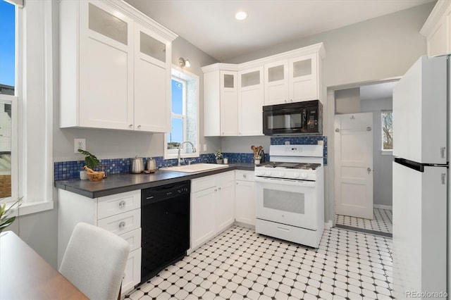 kitchen featuring white cabinetry, sink, and black appliances