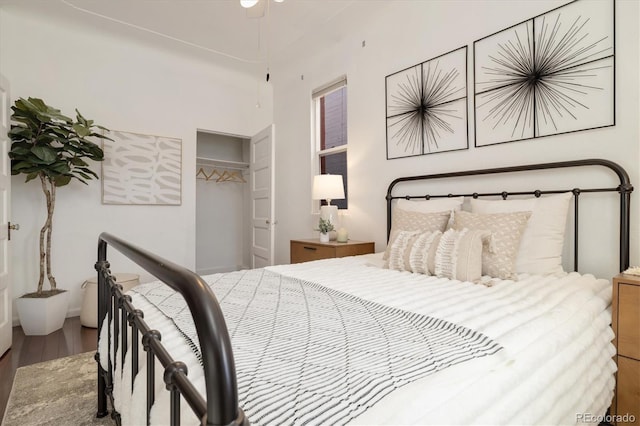 bedroom with wood-type flooring and a closet