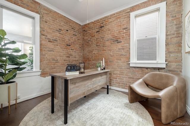 office space with brick wall, ornamental molding, and hardwood / wood-style floors