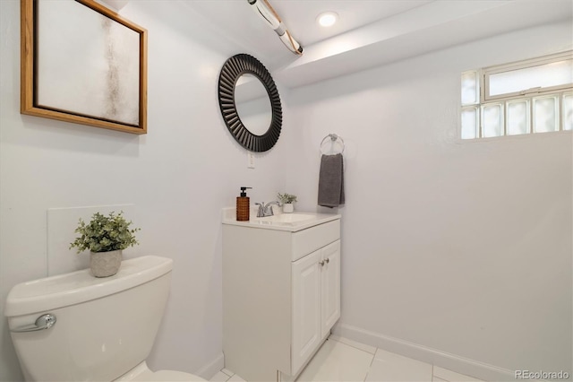 bathroom featuring vanity, tile patterned floors, and toilet