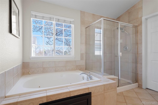 bathroom with tile patterned flooring, a stall shower, and a garden tub