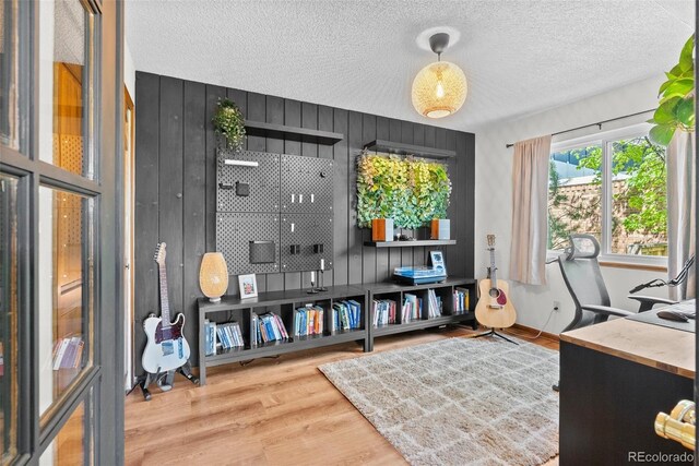 office space with a textured ceiling and wood finished floors