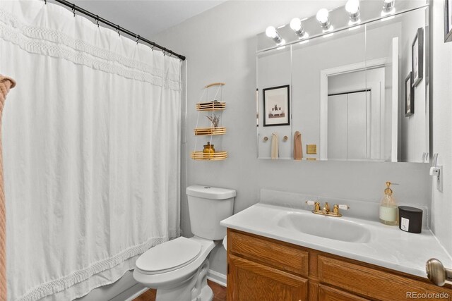 full bath featuring vanity and toilet