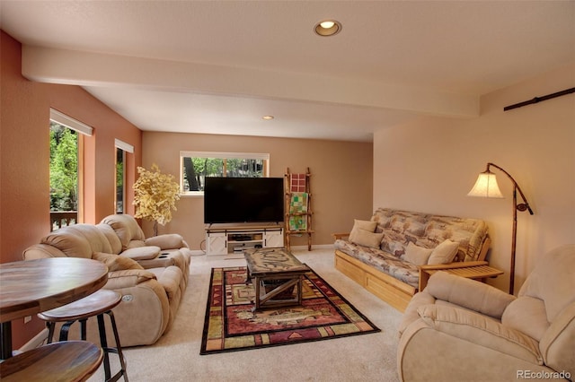 living room featuring beam ceiling and light colored carpet