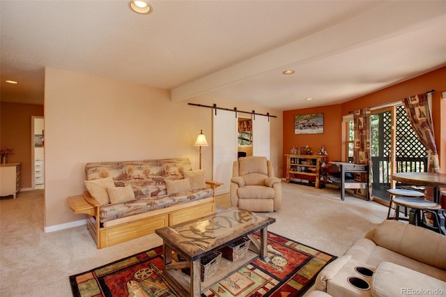 carpeted living room with a barn door and beamed ceiling