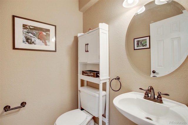 bathroom featuring toilet and sink