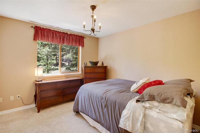 bedroom featuring light colored carpet and a notable chandelier