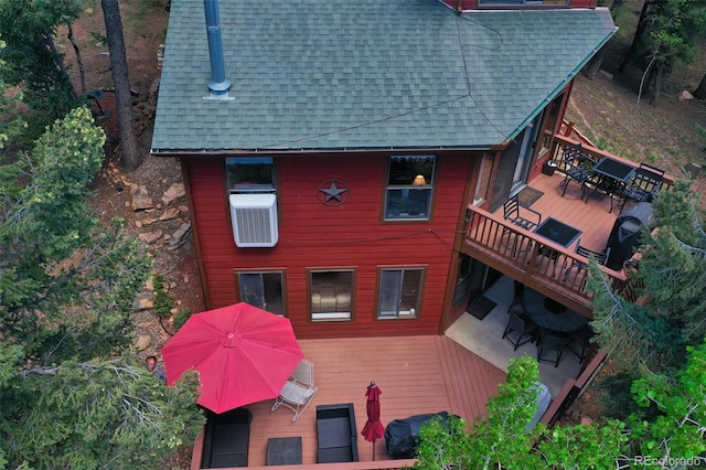 back of property featuring a wooden deck