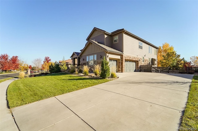 view of home's exterior with driveway, an attached garage, fence, a yard, and board and batten siding