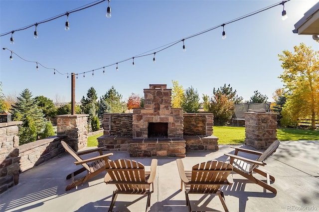 view of patio / terrace featuring an outdoor stone fireplace