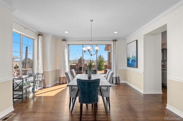 dining room featuring baseboards, visible vents, ornamental molding, dark wood-style flooring, and an inviting chandelier