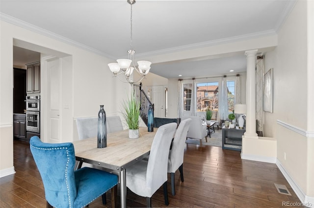 dining space featuring a notable chandelier, visible vents, ornate columns, dark wood finished floors, and crown molding