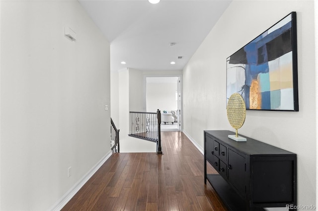 hall with recessed lighting, baseboards, dark wood finished floors, and an upstairs landing