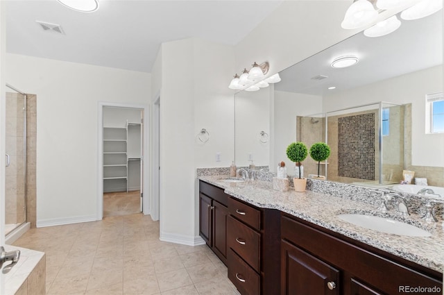 full bathroom featuring a stall shower, a sink, and visible vents