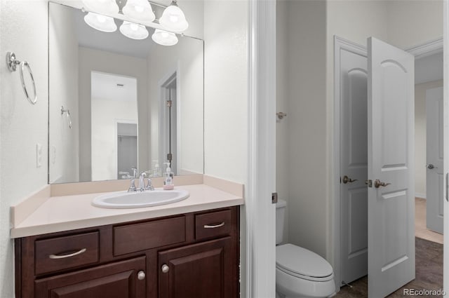 bathroom with vanity and toilet