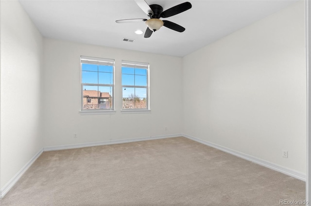 unfurnished room with light carpet, ceiling fan, visible vents, and baseboards