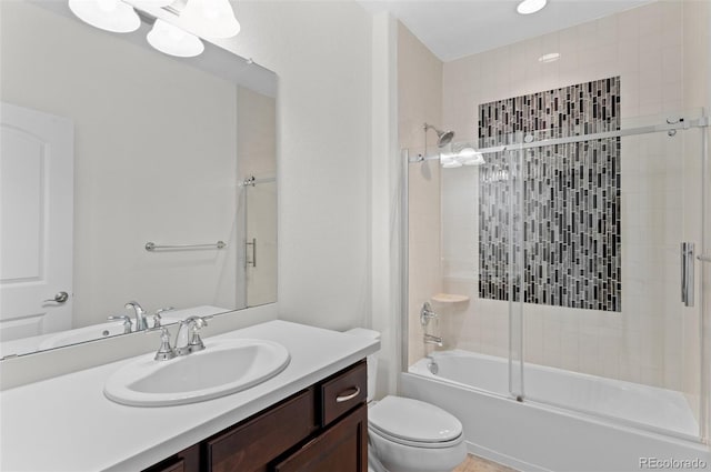 full bath with bath / shower combo with glass door, vanity, and toilet