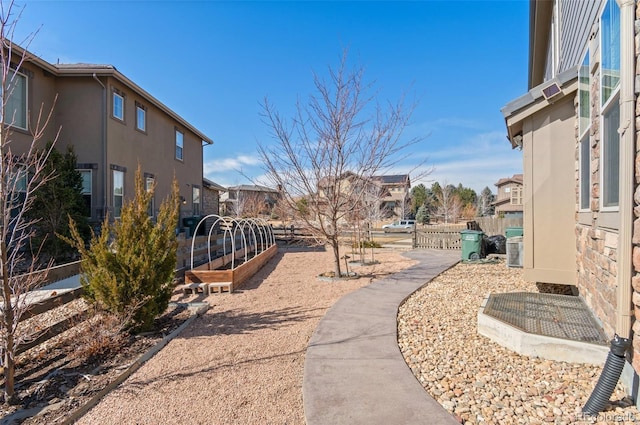 surrounding community with fence and a residential view