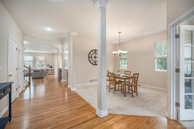 dining space with decorative columns, baseboards, light wood finished floors, a chandelier, and recessed lighting