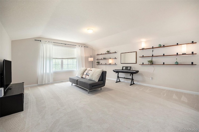 living area with lofted ceiling, light colored carpet, and baseboards