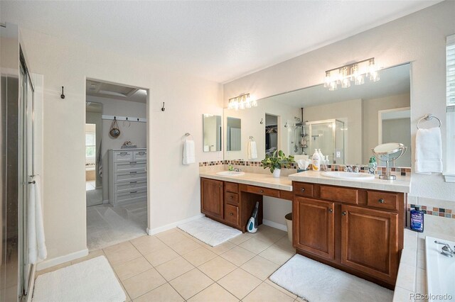 full bathroom featuring a stall shower, tile patterned floors, and double vanity