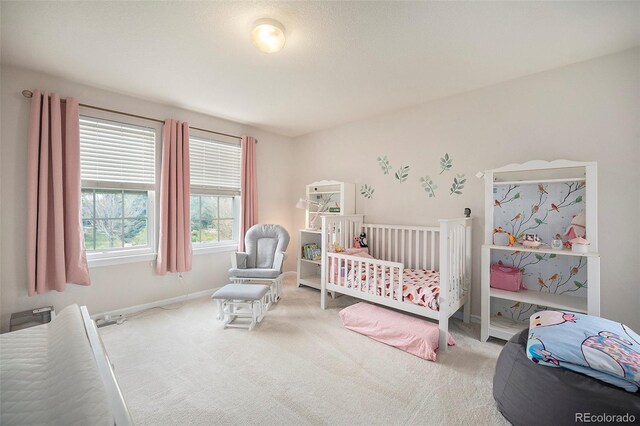 bedroom featuring carpet floors and baseboards