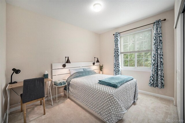 carpeted bedroom featuring baseboards